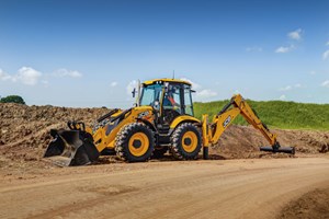 A 5CX Backhoe loader excavating on a dirt path